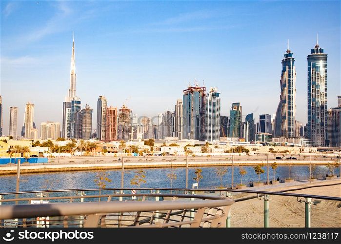 Dubai, UAE - FEBRUARY 2018:Dubai Downtown skyscrapers and Burj Khalifa as viewed from the Dubai water canal
