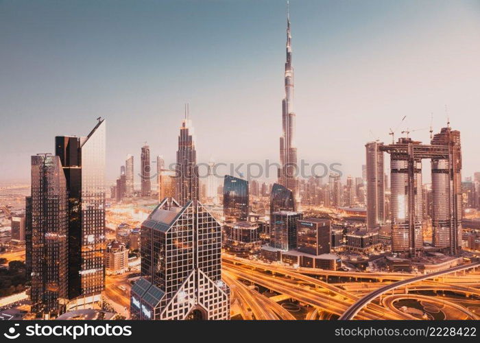 DUBAI, UAE - FEBRUARY 2018  Dubai skyline at sunset with Burj Khalifa, the world tallest building and Sheikh Zayed road traffic