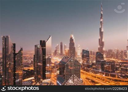 DUBAI, UAE - FEBRUARY 2018  Dubai skyline at sunset with Burj Khalifa, the world tallest building and Sheikh Zayed road traffic