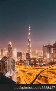 DUBAI, UAE - FEBRUARY 2018  Dubai skyline at sunset with Burj Khalifa, the world tallest building and Sheikh Zayed road traffic