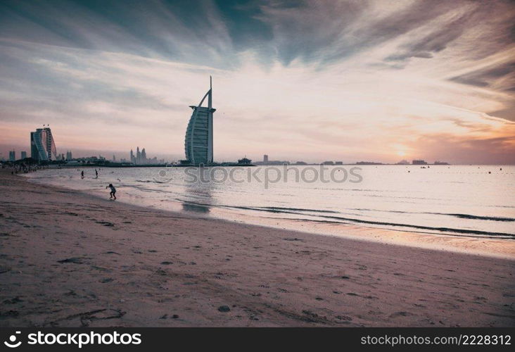 DUBAI, UAE - FEBRUARY 2018  The world’s first seven stars luxury hotel Burj Al Arab at sunset seen from Jumeirah public beach in Dubai, United Arab Emirates