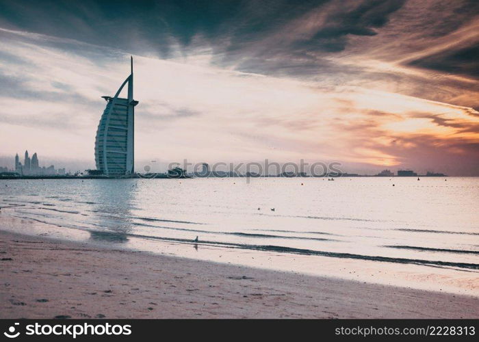 DUBAI, UAE - FEBRUARY 2018  The world’s first seven stars luxury hotel Burj Al Arab at sunset seen from Jumeirah public beach in Dubai, United Arab Emirates