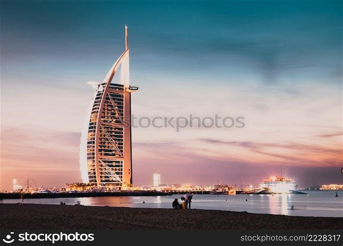 DUBAI, UAE - FEBRUARY 2018  The world’s first seven stars luxury hotel Burj Al Arab at night seen from Jumeirah public beach in Dubai, United Arab Emirates