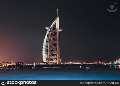 DUBAI, UAE - FEBRUARY 2018  The world’s first seven stars luxury hotel Burj Al Arab at night seen from Jumeirah public beach in Dubai, United Arab Emirates