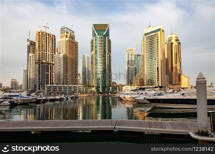 DUBAI, UAE - FEBRUARY 2018: View of modern skyscrapers shining in sunrise lights in Dubai Marina in Dubai, UAE