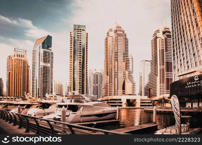 DUBAI, UAE - FEBRUARY 2018  View of modern skyscrapers shining in sunrise lights  in Dubai Marina in Dubai, UAE.