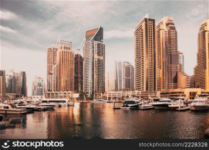 DUBAI, UAE - FEBRUARY 2018  View of modern skyscrapers shining in sunrise lights  in Dubai Marina in Dubai, UAE.