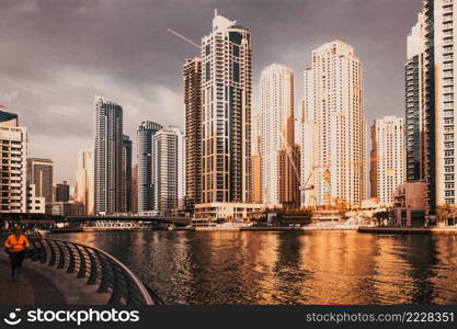 DUBAI, UAE - FEBRUARY 2018  View of modern skyscrapers shining in sunrise lights  in Dubai Marina in Dubai, UAE.