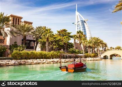 DUBAI, UAE - FEBRUARY, 2018: View on Burj Al Arab, the world only seven stars hotel seen from Madinat Jumeirah, a luxury resort which include hotels and souk spreding across over 40 hectars