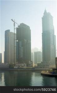 DUBAI, UAE - NOVEMBER 13, 2012: Modern buildings in Dubai Marina in the fog