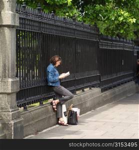 Dublin, Ireland - Brunette standing leaning on fence