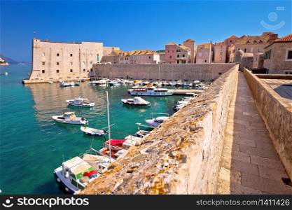 Dubrovnik. Historic city walls walk and Saint Ivan fortress in Dubrovnik harbor view, famous tourist destination in Dalmatia region of Croatia