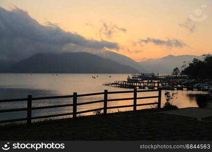 Duck pedal boat pier at sunset at Chuzenji lake, Nikko, Japan