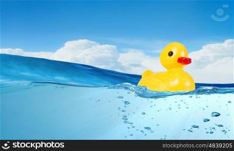 Duck toy. Yellow rubber duck toy floating in water