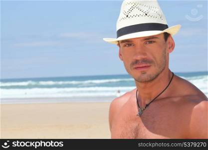 Dude in a straw hat on a sunny beach