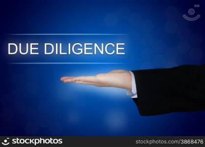 Due diligence button with business hand on blue background