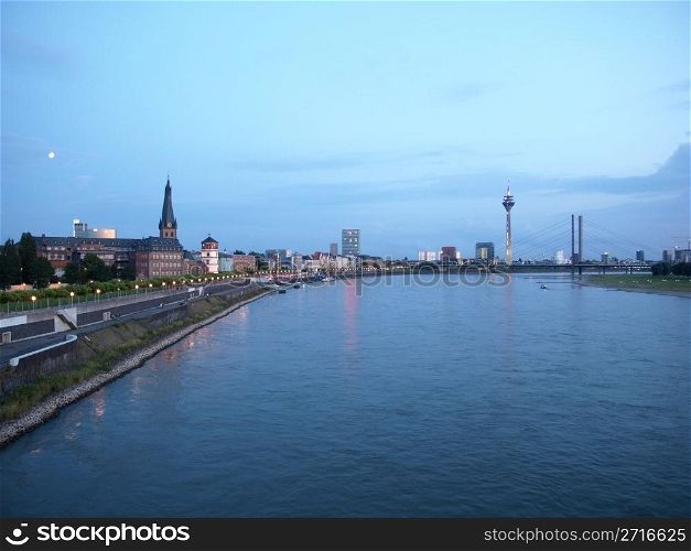 Duesseldorf skyline at night with Rheinturm and river. Duesseldorf, Germany
