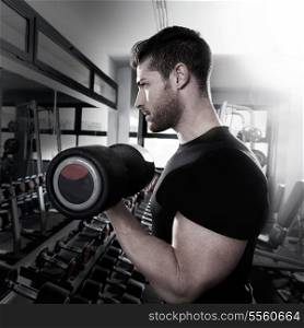 Dumbbell man at gym workout biceps fitness weightlifting