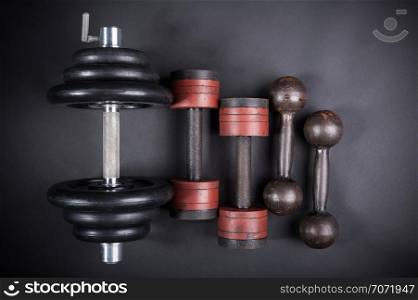 dumbbell with typesetting discs weighting on dark background