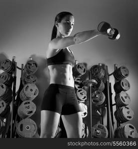 Dumbbell woman workout fitness club at weightlifting gym