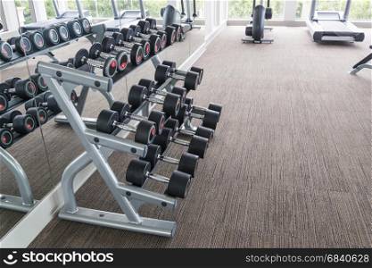 dumbbells in modern sports club. Weight Training Equipment