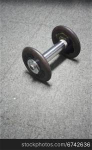 dumbell on ground, in a gymnasium