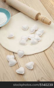 Dumplings in a heart shape dough and rolling pin.