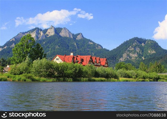 Dunajec river and Three Crowns peak in Pieniny mountains at summer, Poland .. Dunajec river and Three Crowns peak in Pieniny mountains at summer, Poland