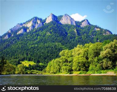 Dunajec river and Three Crowns peak in Pieniny mountains at summer, Poland .. Dunajec river and Three Crowns peak in Pieniny mountains at summer, Poland