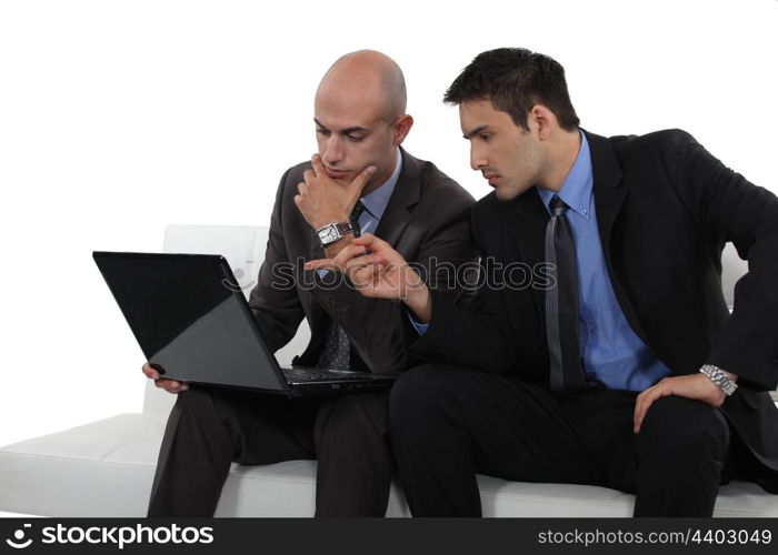 duo of businessman with laptop exchanging views