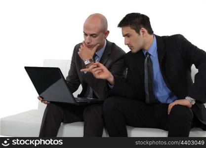 duo of businessman with laptop exchanging views