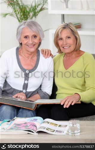 duo of grandmothers skimming through album