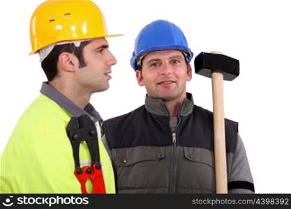 duo of male carpenters against studio background