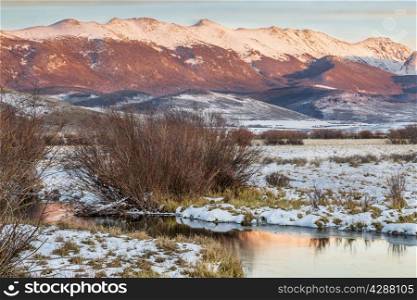 dusk over Canadian River and Medicine Bow Mountains in North Park near Walden, Colorado, late fall scenery