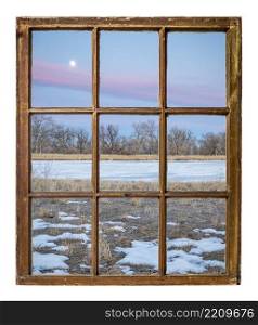 dusk over Colorado plains with a frozen lake, vintage sash window view