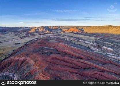 dusk over foothills of Rocky Mountains in northern Colorado with red sandstone and canyons, aerial view