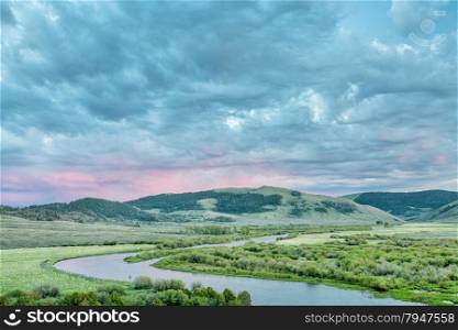 dusk over North Platte River in Colorado North park above Northgate Canyon, early summer scenery with waterfowl