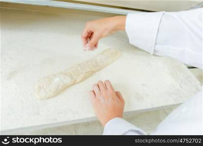 Dusting a baguette with flour