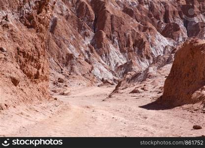 Dusty gravel road with a tight bend in the Valle de Muerte