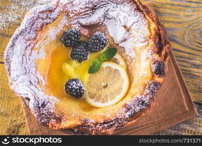 Dutch Baby pancake served with melted butter and fresh berries