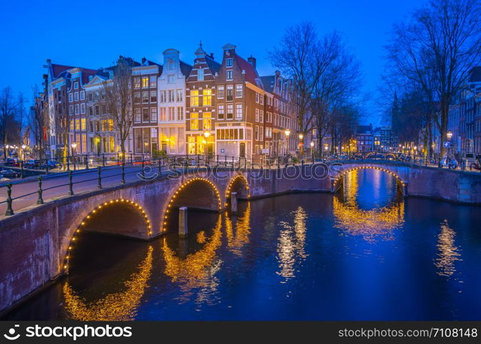 Dutch buildings in Amsterdam at night in Netherlands.