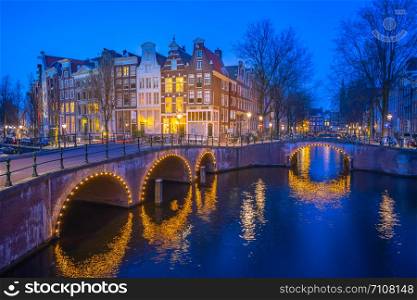 Dutch buildings in Amsterdam at night in Netherlands.