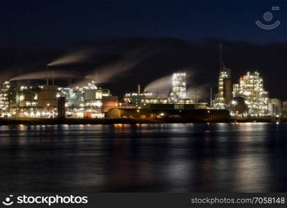 Dutch Chemical plant in Dordrecht on the shore of the river Merwede. Chemical factory along the river Merwede