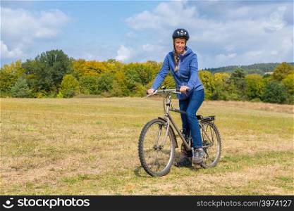 Dutch female mountain biker on bicycle in natural landscape