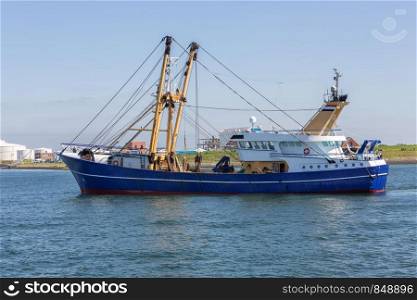 Dutch fishing cutter sailing into harbor Vlissingen, The Netherlands. Fishing cutter sailing into harbor Vlissingen, The Netherlands