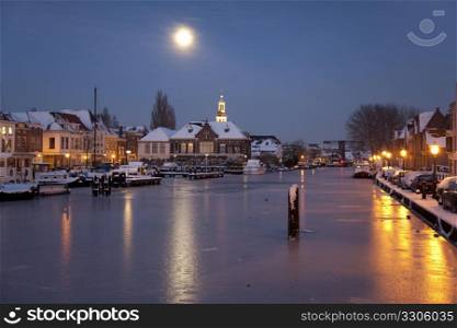 Dutch harbour in moonlight in winter