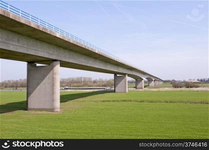 Dutch highway bridge with concrete pylons crossing the river IJssel near the city of Zutphen, the Netherlands on april 7, 2010.