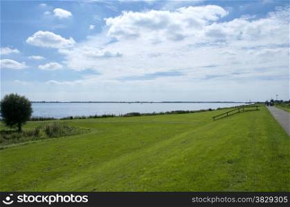 Dutch landscape near the lake Haringvliet with blue sky and clouds in summer