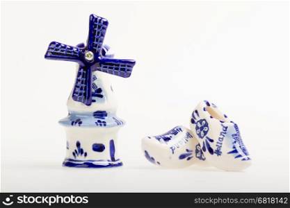 Dutch mini porcelain windmill and clogs on a white background
