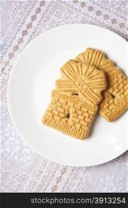 Dutch windmill cookie on dinner plate on table